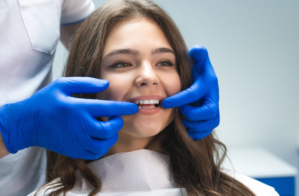 A dentist showing a female patient her new veneers